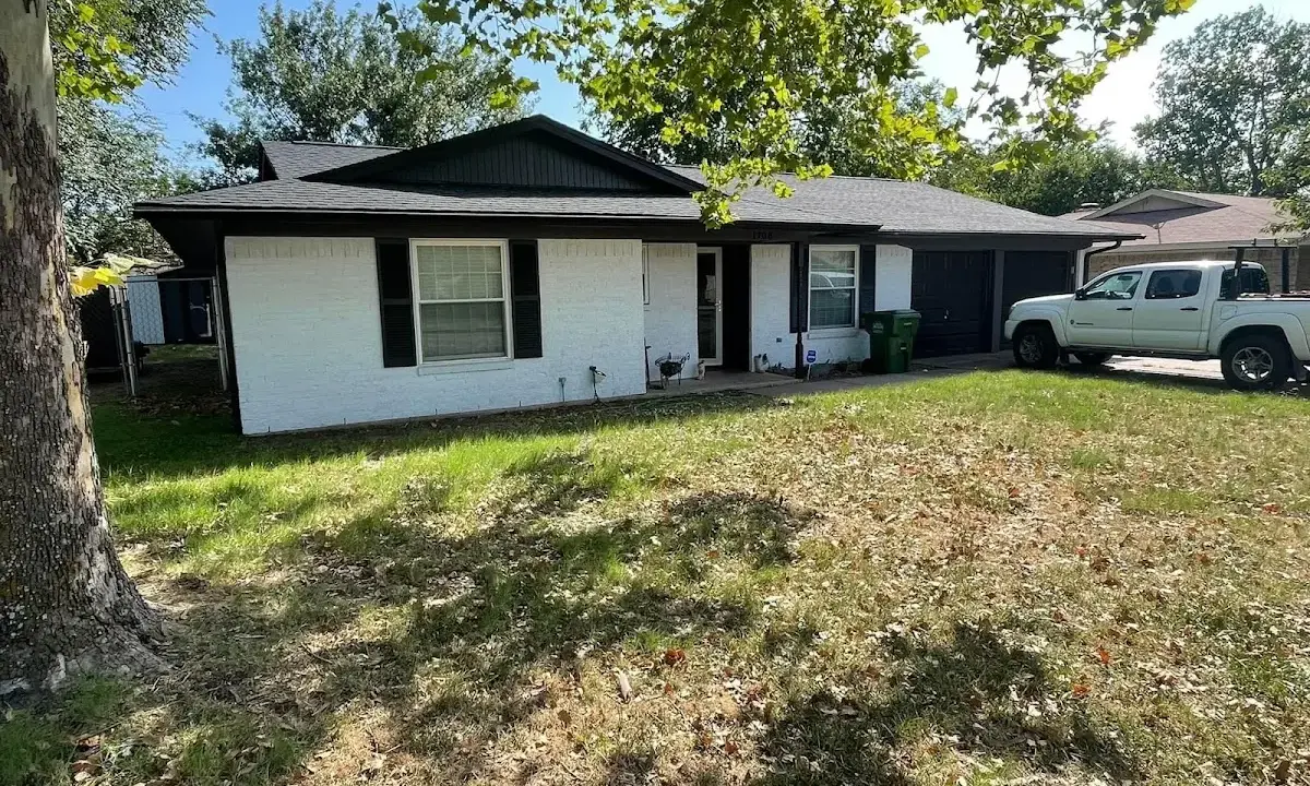 Professional roofing crew working on a residential roof in St. Francis